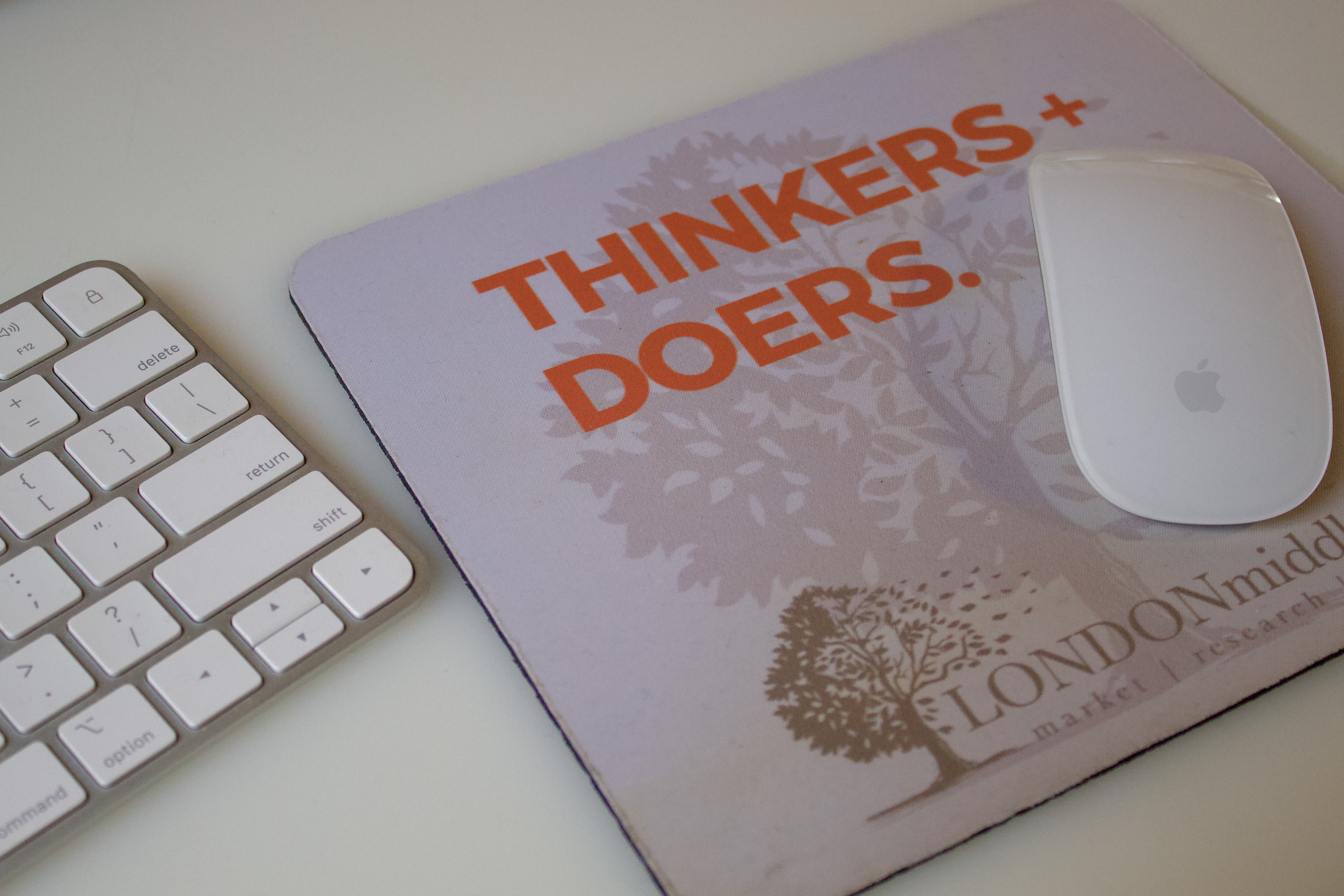 A mousepad with the words "Thinkers and Doers" written on the top